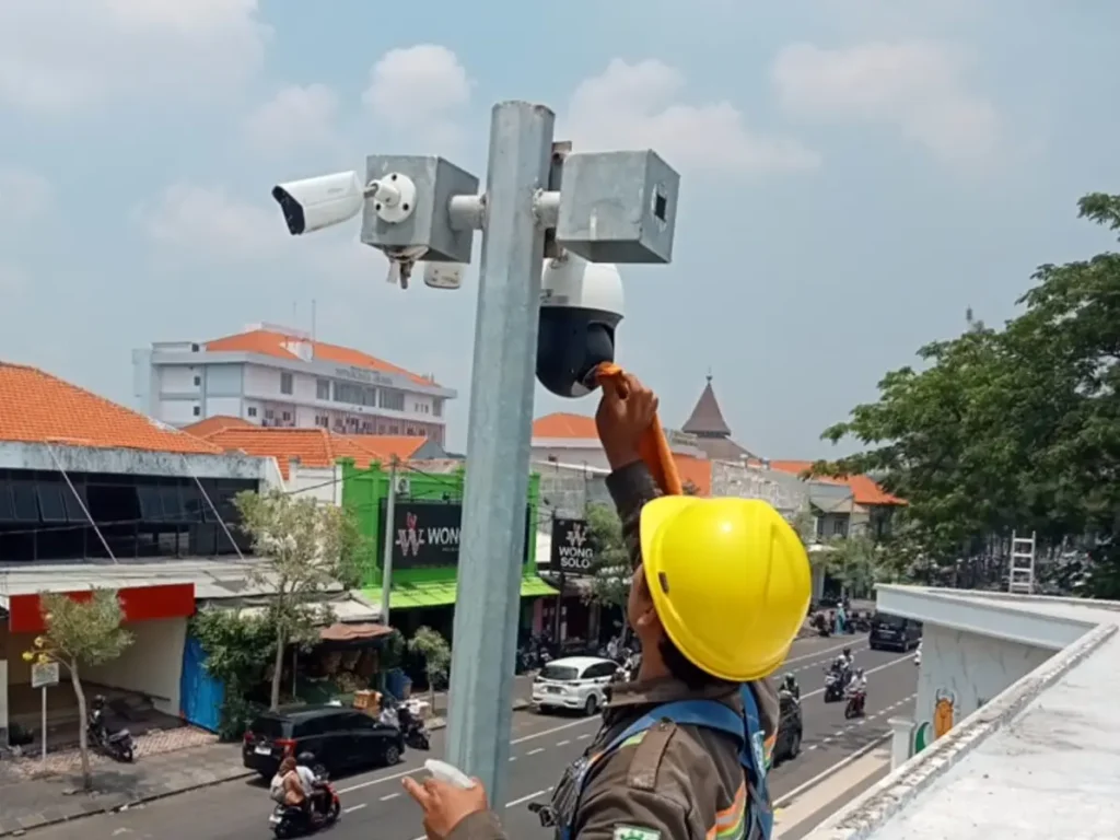 Teknisi CCTVSurabaya.com sedang membersihkan kubah kamera PTZ Outdoor di tiang tinggi area Jalan Urea Raya, Karangpoh, Gresik, Jawa Timur.